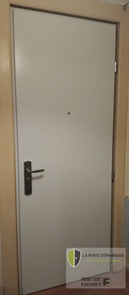 Installation d'une porte de sécurité dans le quartier de La Terrasse à Saint-Étienne par La Porte Stéphanoise. Remplacement d'une ancienne porte moulurée par une porte de sécurité qui améliore l'isolation thermique et phonique et est coupe feu 30 minutes. Photo intérieur de la nouvelle porte